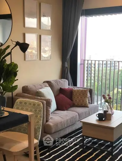 Cozy living room with stylish decor and balcony view, perfect for relaxation and entertaining.