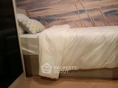 Cozy bedroom with modern decor and stylish wall art, perfect for relaxation and comfort.