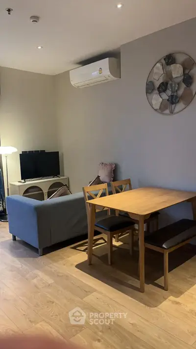 Modern living room with wooden dining set and cozy sofa