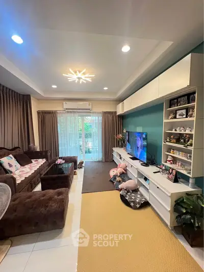 Spacious living room with modern decor and large windows for natural light.