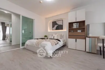 Modern bedroom with stylish decor and ample natural light, featuring a cozy bed and elegant furnishings.