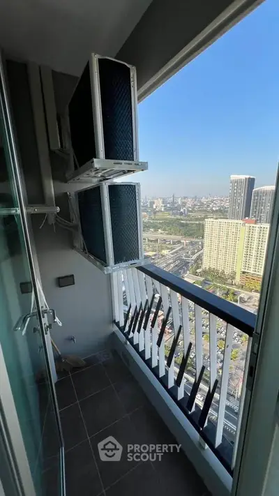 High-rise balcony with city view and air conditioning units, perfect for urban living.