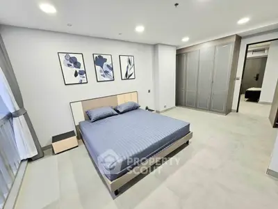 Spacious modern bedroom with elegant decor and large windows