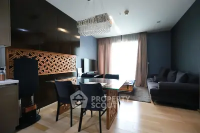 Elegant living room with modern decor, featuring a stylish chandelier and cozy seating area.