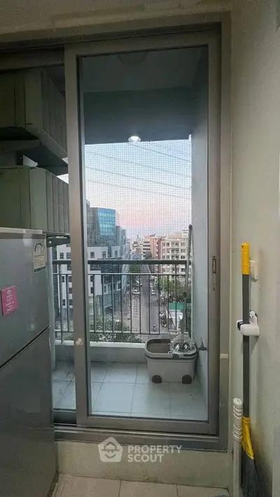 Modern apartment balcony with city view and utility area, perfect for urban living.