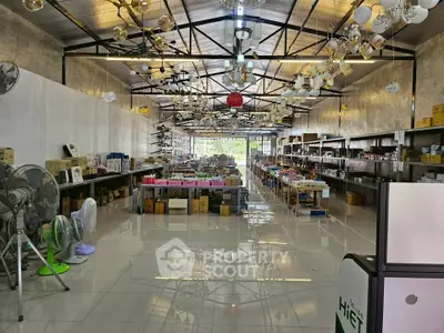 Spacious warehouse interior with high ceilings and ample shelving space.