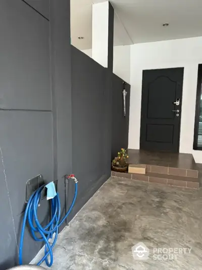 Modern entrance with sleek design and concrete flooring