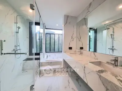 Luxurious marble bathroom with glass shower and soaking tub
