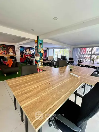 Modern coworking space with vibrant decor and spacious seating area