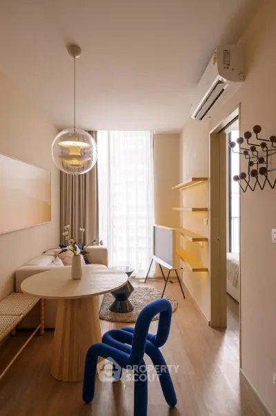 Stylish modern living room with unique blue chair and elegant decor