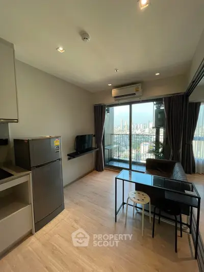 Modern living room with balcony and city view, featuring sleek furniture and natural light.