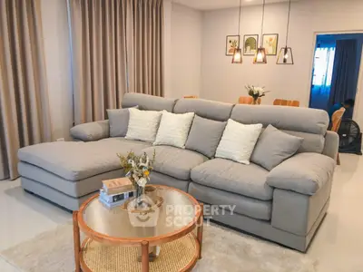 Spacious living room with plush gray sectional sofa and elegant decor