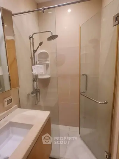 Modern bathroom with glass shower enclosure and sleek fixtures