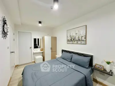 Modern bedroom with stylish decor and comfortable bedding in a contemporary apartment.