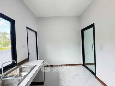 Bright kitchen with sleek sink and large windows in modern home