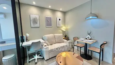 Modern living room with cozy sofa, stylish decor, and dining area
