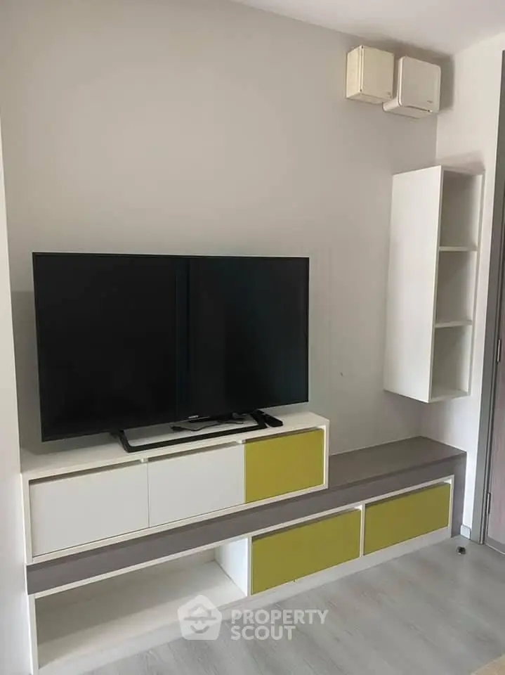 Modern living room with sleek TV unit and stylish shelving