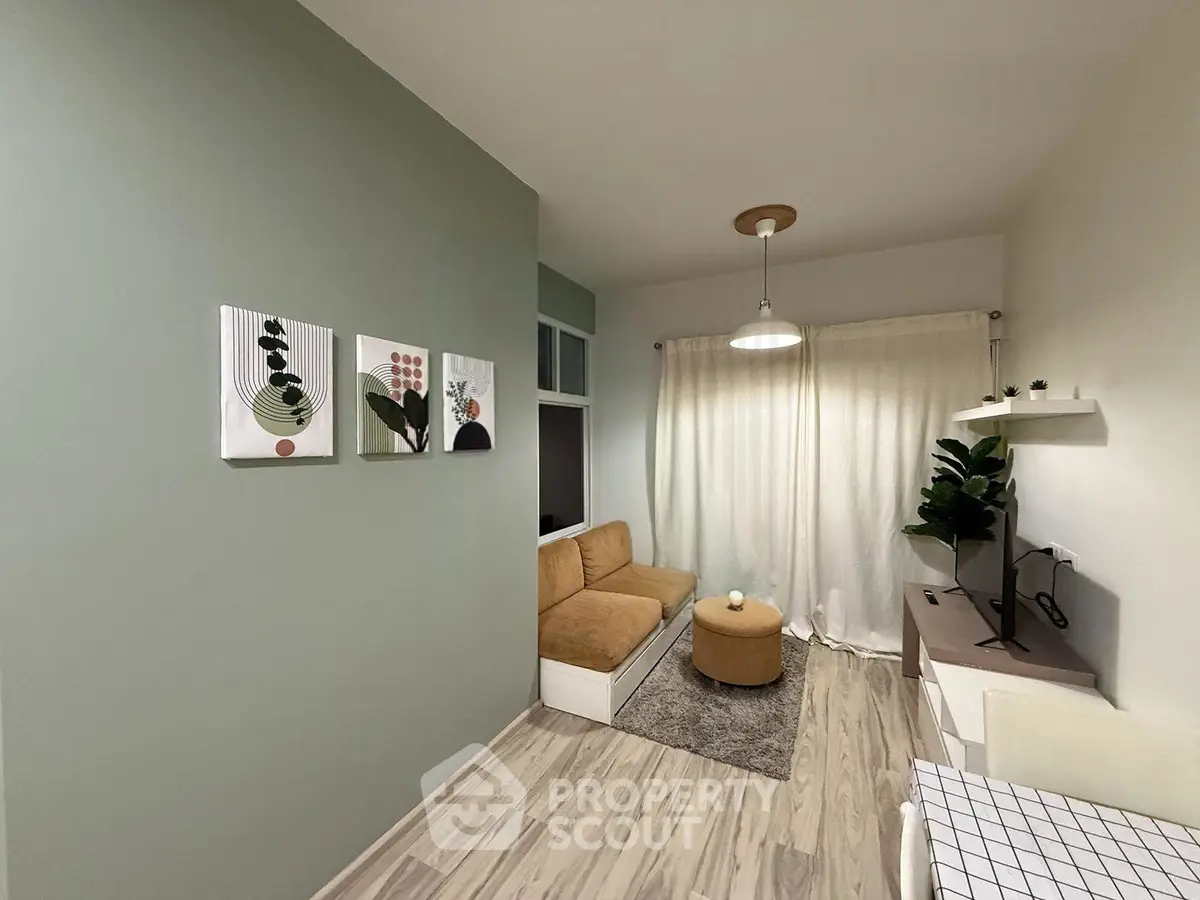 Cozy living room with modern decor and natural light, featuring a stylish sofa and elegant wall art.