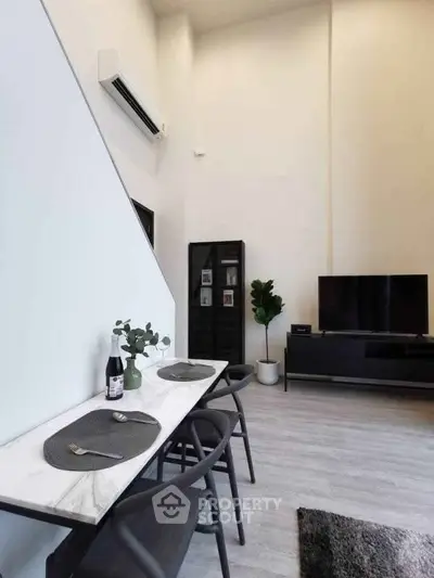 Modern living room with sleek furniture and high ceiling, perfect for contemporary lifestyle.