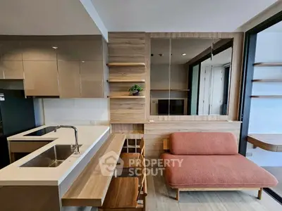 Modern open-plan living room with stylish kitchen and cozy seating area.