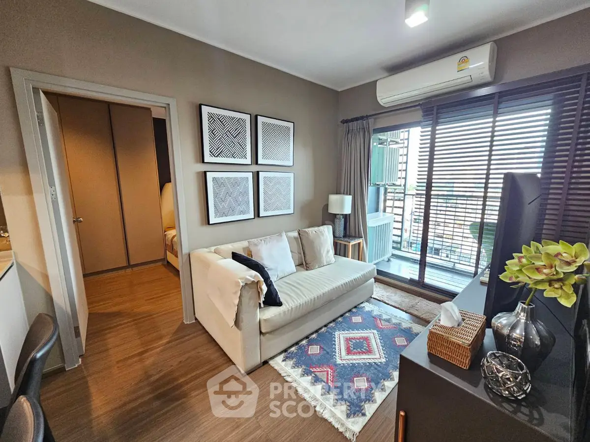 Modern living room with cozy sofa, stylish decor, and balcony access in a contemporary apartment.