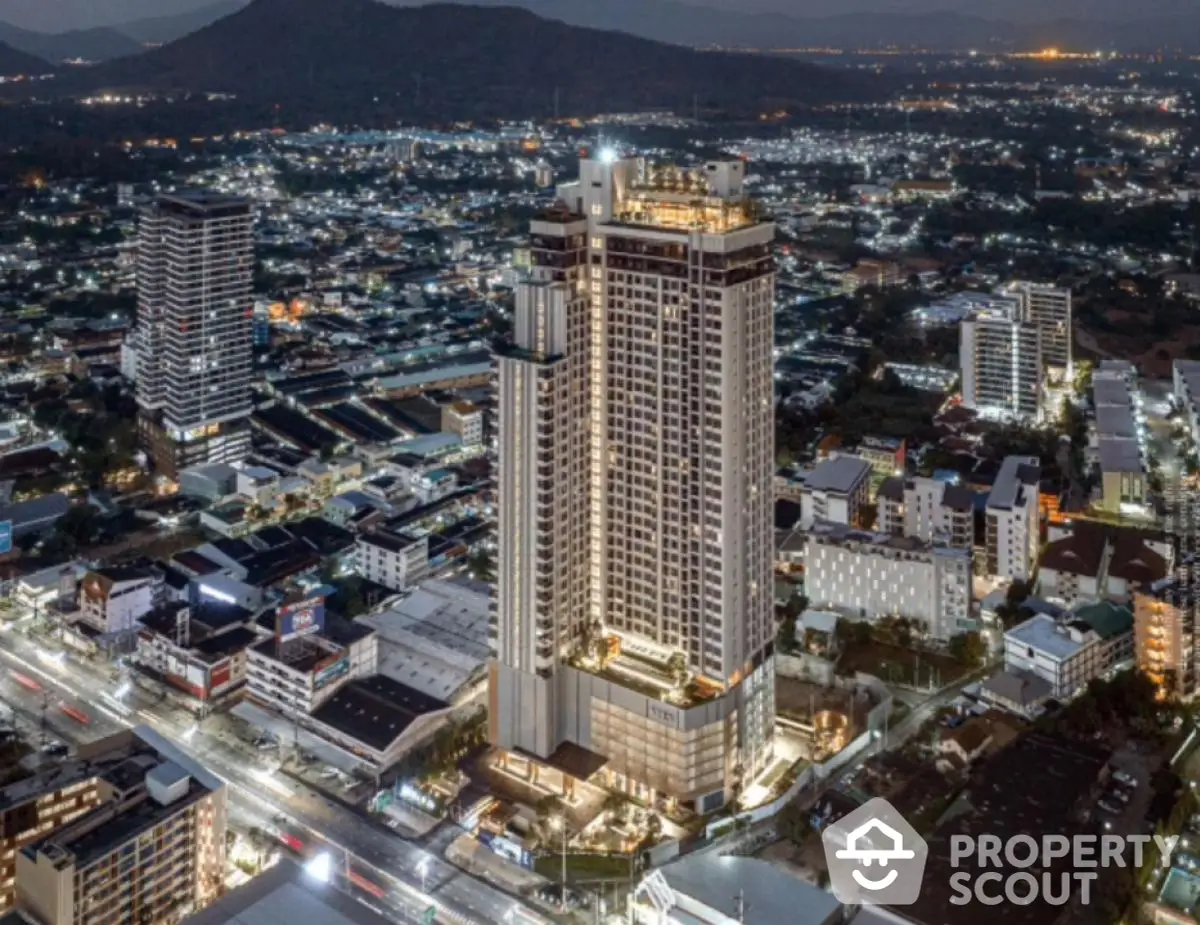 Stunning aerial view of modern high-rise building in vibrant cityscape at night