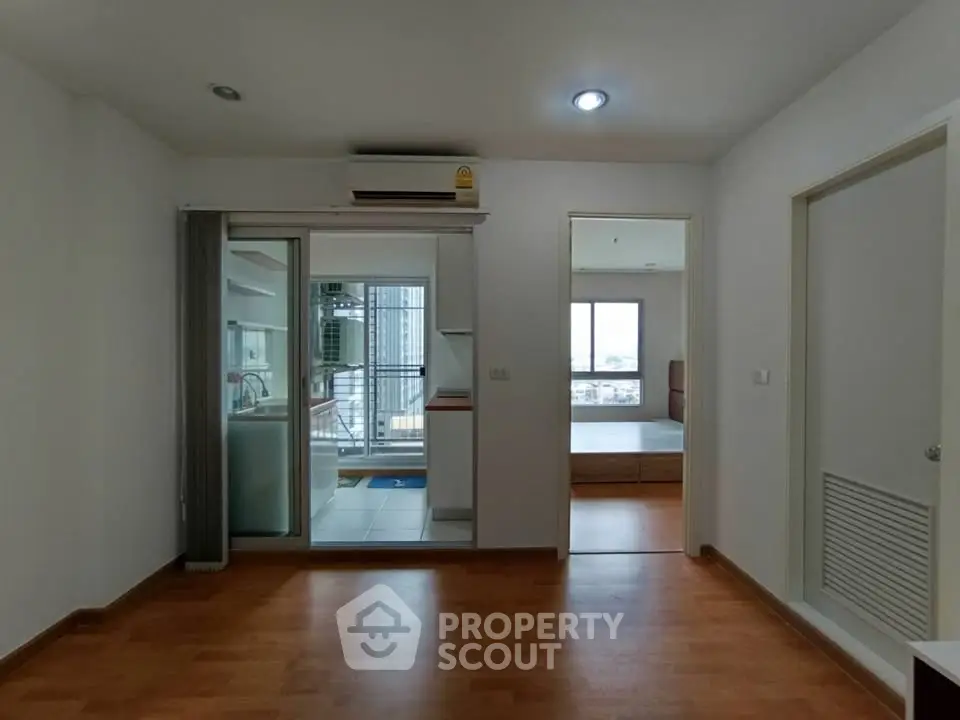Modern apartment interior with wooden flooring and balcony view