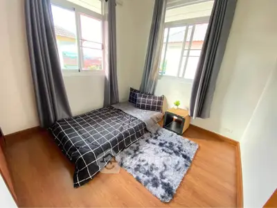 Cozy bedroom with modern decor and large windows for natural light