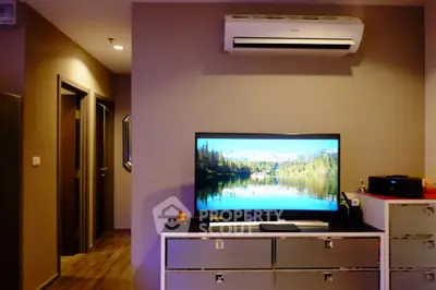 Modern living room with sleek TV setup and air conditioning unit, perfect for cozy entertainment.