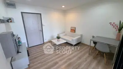 Modern living room with sleek furniture and wooden flooring, perfect for cozy gatherings.