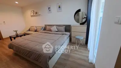 Spacious modern bedroom with stylish decor and natural light