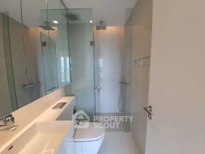 Modern bathroom with glass shower and sleek fixtures