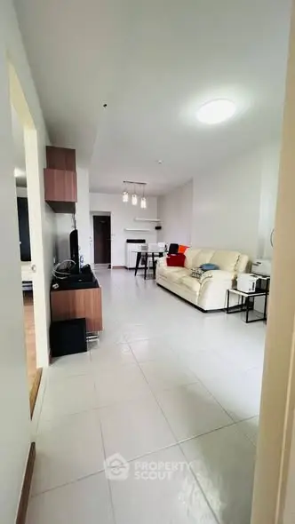 Spacious modern living room with elegant decor and ample natural light.