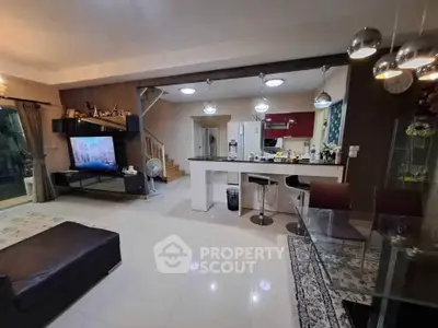 Spacious open-plan living room with modern kitchen and stylish decor