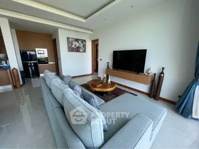 Spacious modern living room with stylish decor and large TV