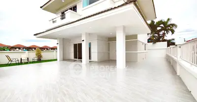 Spacious modern house with large tiled patio and elegant design.