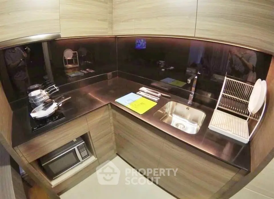 Modern kitchen with sleek wooden cabinets and stainless steel appliances
