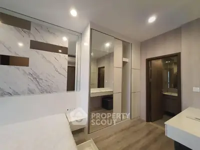 Modern bedroom with stylish decor and mirrored closet doors