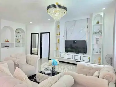 Luxurious living room with elegant chandelier and plush seating in modern home.