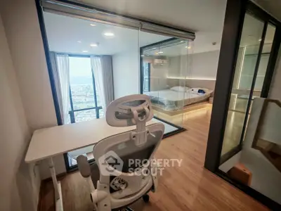 Modern study room with ergonomic chair and glass-walled bedroom offering city views.