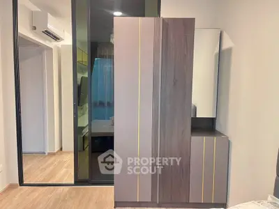 Modern bedroom with sleek wardrobe and glass sliding door