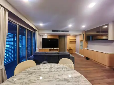 Spacious modern living room with open layout and large windows for natural light.
