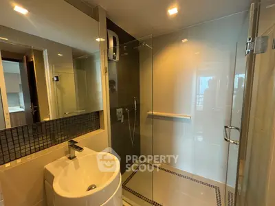 Modern bathroom with glass shower and sleek sink design