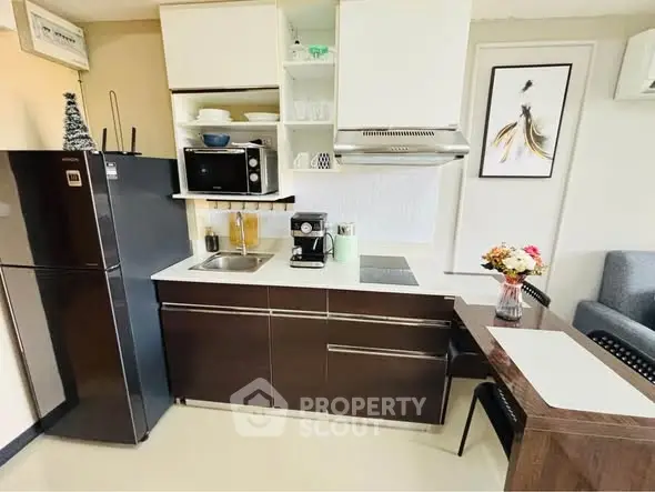 Modern kitchen with sleek cabinetry, stainless steel appliances, and cozy dining area.