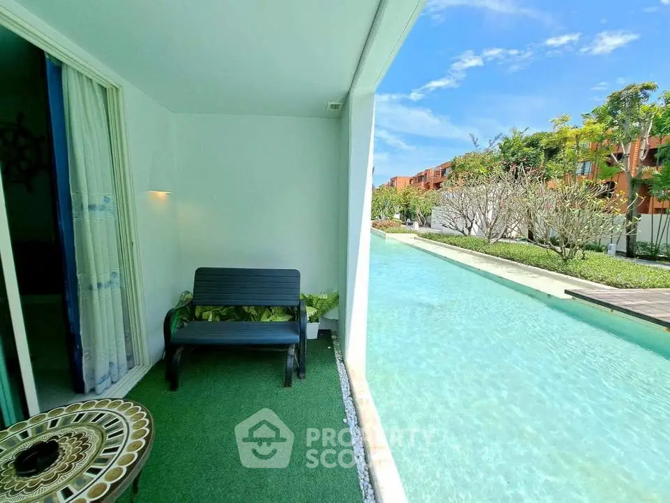 Luxurious poolside patio with lush greenery and serene water views