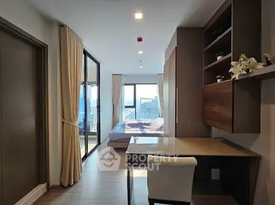 Modern bedroom with study area and large windows offering city views