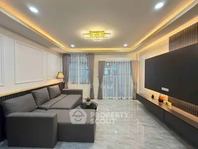 Spacious modern living room with elegant lighting and sleek furniture