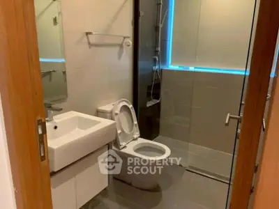 Modern bathroom with glass shower and sleek fixtures