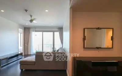 Spacious living room with modern decor and large windows for natural light.