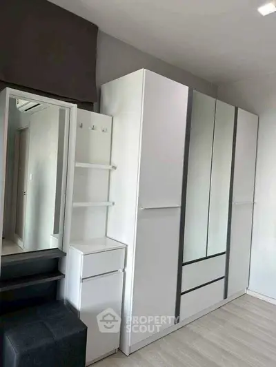 Modern bedroom with sleek white wardrobe and minimalist design